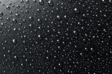 Water Drops On Black Surface, Abstract Background.