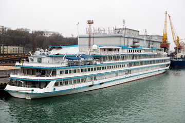 Passenger ship in the port. Passenger liner in the port. A beautiful white large passenger ocean liner.