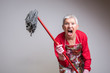 © Teodor Lazarev - Cleaning senior lady had enough, threatening to beat you with a mop