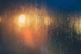 Fototapeta  - Rain drops on the window against bokeh lights