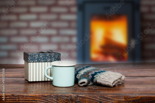 Vintage Bright Green Cup With Hot Tea And Warm Gloves On Wooden