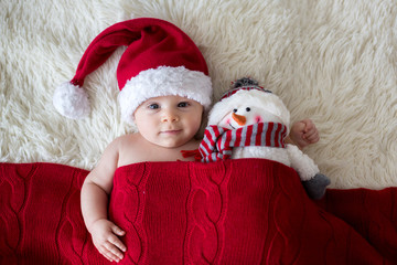 Wall Mural - Christmas portrait of cute little newborn baby boy, wearing santa hat