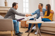 © Viacheslav Yakobchuk - Therapy works. Male psychologist shaking hands with husband who smiling and embracing his wife