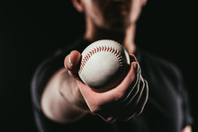 Selective Focus Of Man Holding Baseball Ball Isolated On Black