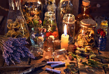 Bottles With Herbs, Lavender Flowers, Paper Scrolls And Magic Objects On Witch Table. Occult, Esoteric, Divination And Wicca Concept. Mystic, Old Apothecary And Vintage Background