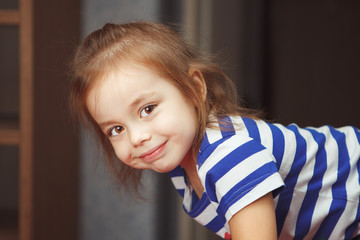 Wall Mural - Girl with cheerful smile stands on her hands and legs