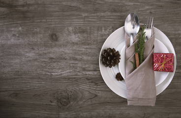 Dinner plate setting on wood table top view.