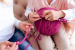 © zinkevych - Time for knitting. Close up of a pink ball of yard being used by a delighted nice aged woman for knitting