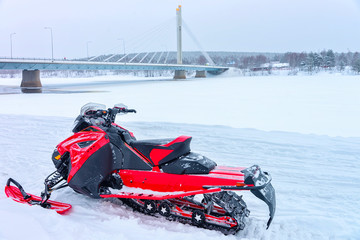 Poster - Red snowmobile on frozen lake at Candle bridge winter Rovaniemi