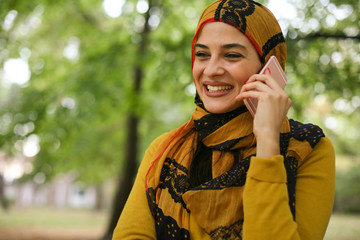 young muslim woman talking on smart phone.