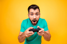 I Am Number One In Playing Games! Close Up Portrait Of Funny Joyful Cheerful Happy Guy, He Is Rejoicing His Victory With Gamepad In Hands, Isolated On Bright Yellow Background