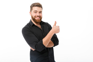 Wall Mural - Smiling bearded man in shirt showing thumb up