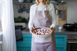 © LUMINA IMAGES - Cropped senior Caucasian woman holding delicious fruit pie and standing at kitchen.