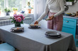 © LUMINA IMAGES - Hands of unrecognisable woman setting up dinning table.
