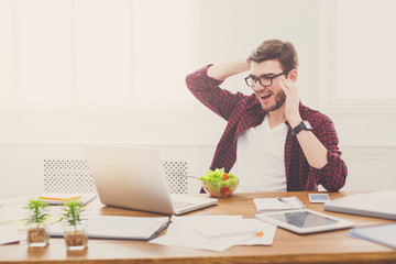 Wall Mural - Man has healthy business lunch in modern office interior