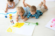 © Africa Studio - Children lying on floor in light room and painting