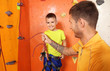 © Africa Studio - Little boy with trainer in climbing gym