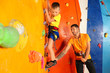 © Africa Studio - Little boy with trainer in climbing gym