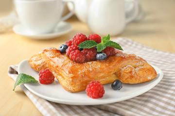 Poster - Plate with yummy berry puff pastry on table