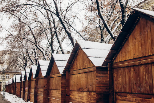 Wooden Cabins In Snow For Christmas Market Snowy Town Square In