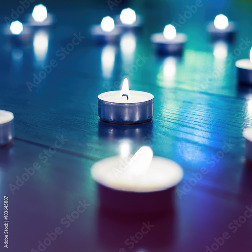Small White Candles With Blurred Blue Purple Background This Small White Candles With Blurred Blue Purple Background