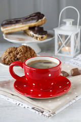 Canvas Print - Cup of coffee and eclairs with chocolate