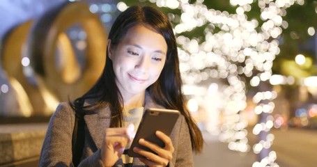 Poster - Woman look at mobile phone in city at night