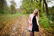 © AS Photo Family - Young blonde girl at pink coat posed on autumn park.
