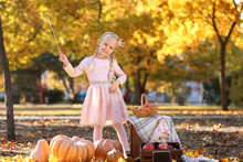 Cute Little Girl Wearing Princess Costume In Autumn Park