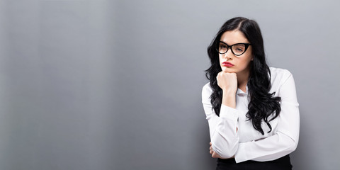 Bored young business woman on a solid background