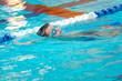 © Michael - Close up of young boy swimming in pool.
