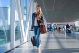 Happy woman travelling and walking in airport
