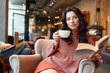 woman drinking coffee in a cafe