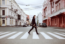 Guitarist In Dark Clothes Crosses The Street On The Transition