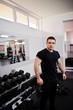 © AS Photo Family - Young man doing exercises and working hard in gym and enjoying his training process.