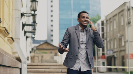 African american joyful businessman happy after talking phone about his new career