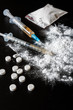Drug heroin, syringes, money on a dark background with copy space, concept of crime and addiction