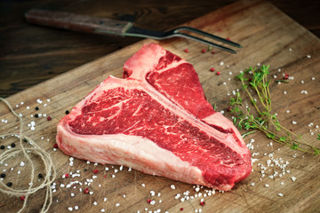 Sticker - raw t bone steak on wooden Board rustic style