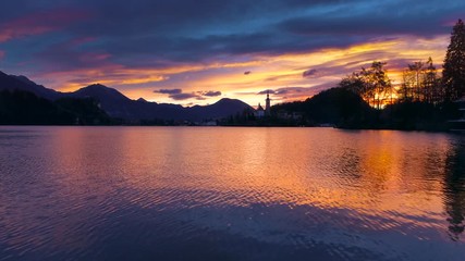 Wall Mural - aerial sunset view of church of assumption in lake bled, slovenia. beautiful nature resort bled vide