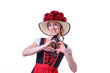 Woman wearing Black Forest dress showing heart sign
