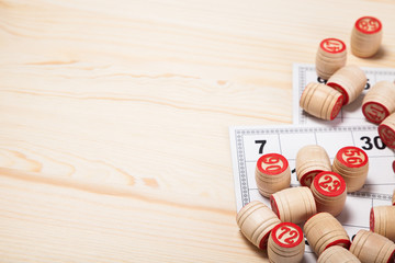 Wall Mural - Bingo lotto on wooden background with copy space. Balls with bingo numbers, bingo cards. Flat lay.