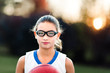 © Connect Images - Portrait of girl wearing sports goggles holding basketball