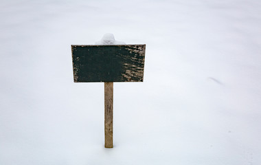 Street direction pointer without signs and symbols in the snow
