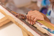 Close up of painter holding paint brush and frame, in a studio paint background