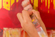 Close up of a paint brush over a color palette in a blurred background