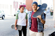 © Sergey Nivens - Teenager boy walking at the street with his skateboard