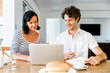 © Sergey Nivens - Happy modern couple working on laptop at home