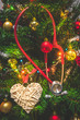 Close up view of a red stethoscope hanging on a decorated Christmas tree with baubles or balls, hearts and shining colorful Christmas lights. Medical Christmas or Holiday in hospital concept