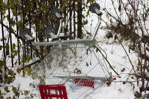 Shopping Cart Lies Overturned In The Snow Buy This Stock Photo