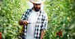 © NDABCREATIVITY - Young farmer protecting his plants with chemicals